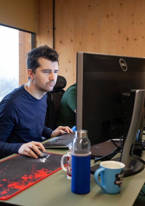 modern developer at desk with AI coding assistant floating above screen